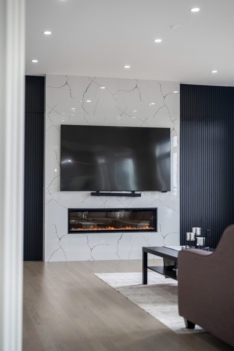 Modern living room with fireplace and large television.
