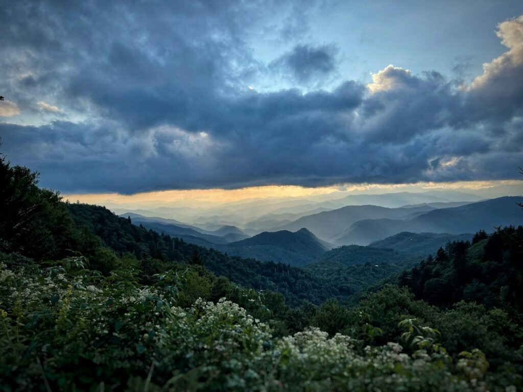 a view of a mountain range with clouds in the sky