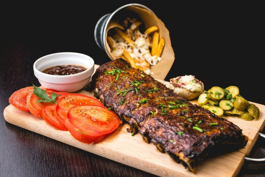 How to Cook Indoors and Still Get That Grilled Flavor 8 roasted ribs with sliced tomatoes and potatoes