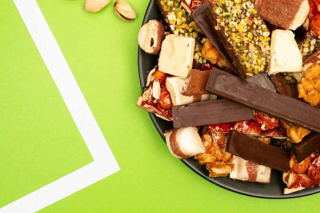 A plate full of assorted energy bars and nuts.