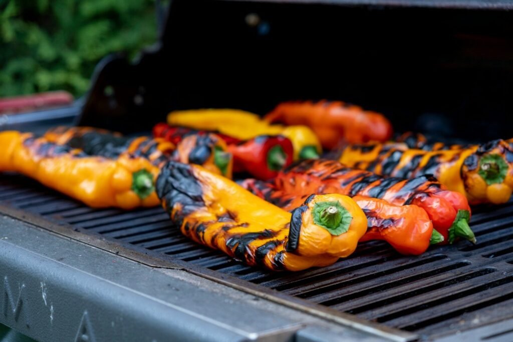 Foods That Taste Better on the Grill; Colorful bell peppers grilling on a barbecue