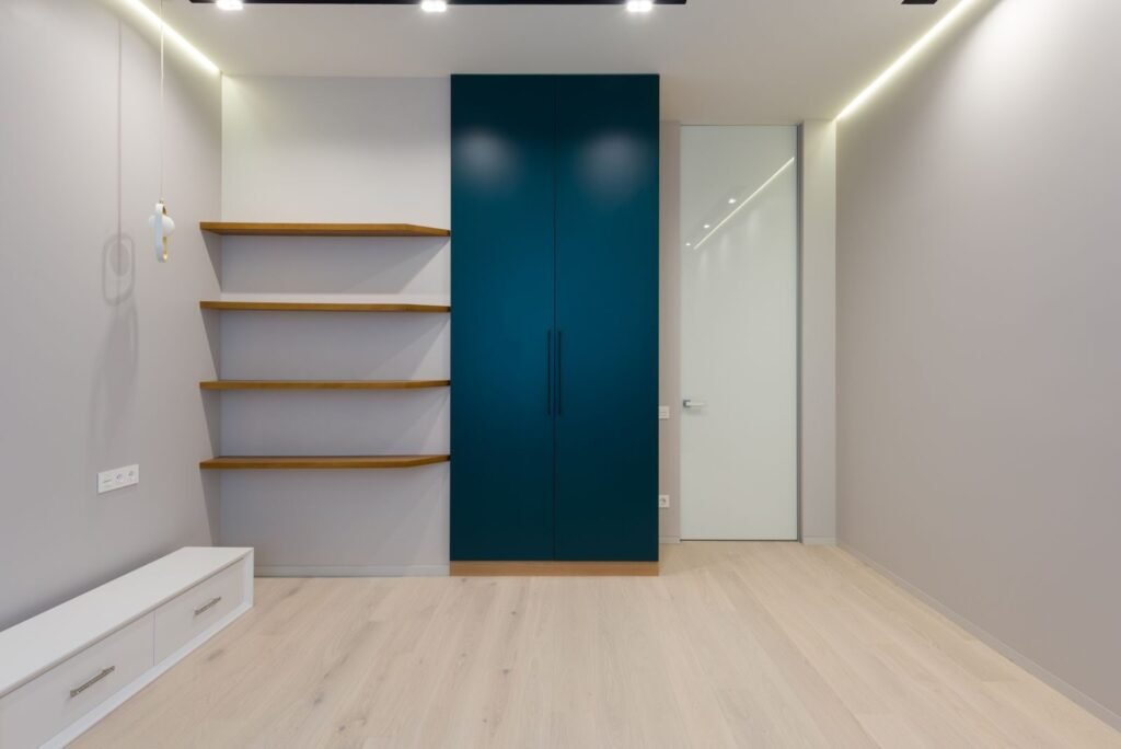 How to Build Floating Shelves; Minimalist wooden furniture with shelves and wardrobe in spacious room with laminate floor and bright lamps